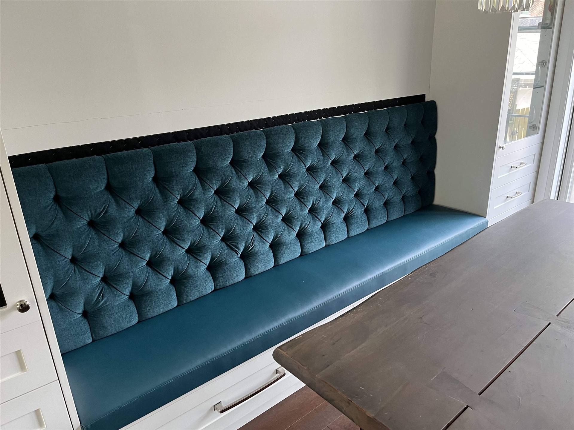 Teal tufted leather banquette